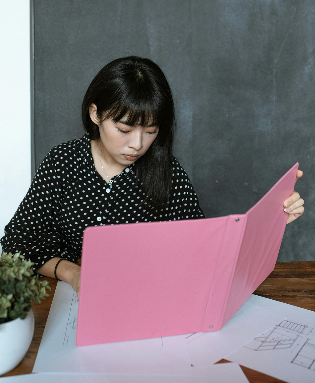 Offshore professional working on a laptop in a collaborative office environment